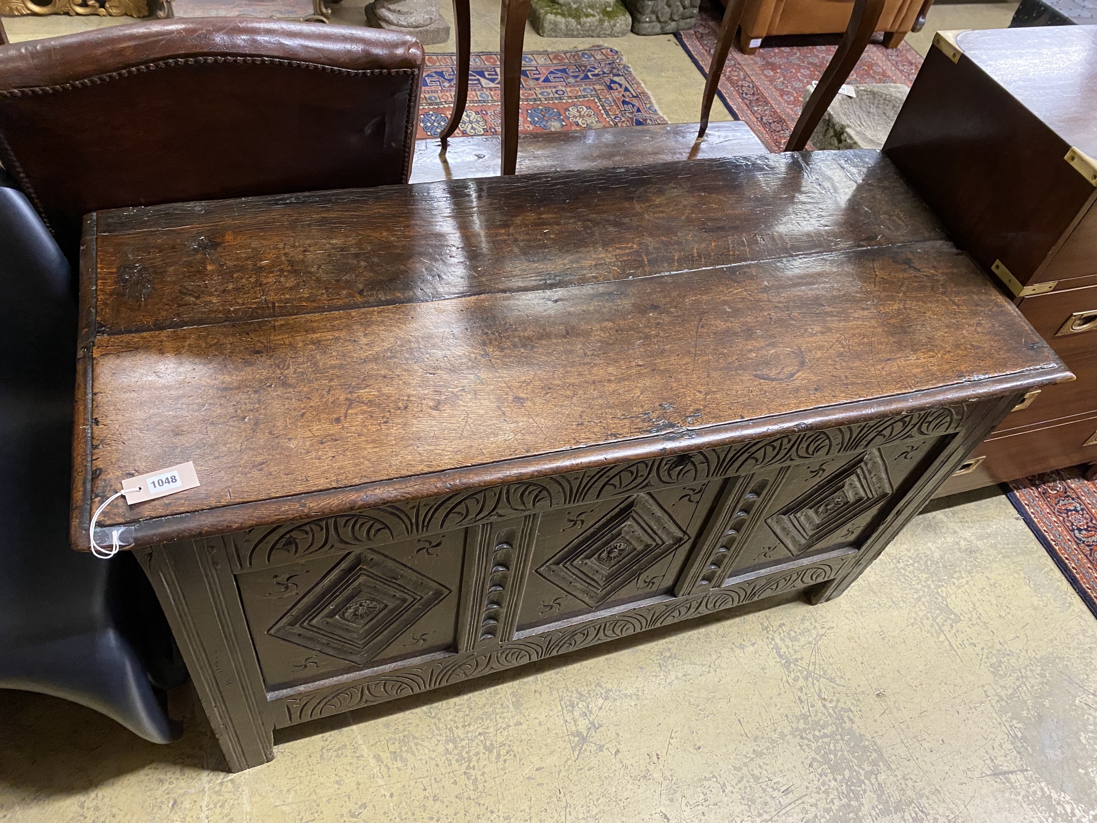 An 18th century carved panelled oak coffer, length 130cm, depth 54cm, height 72cm